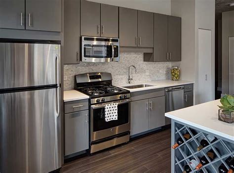 dark gray kitchen cabinets with stainless steel appliances|kitchen with gray cabinets.